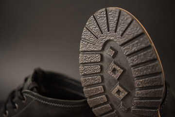 vintage black boots on black background, detail of retro shoes