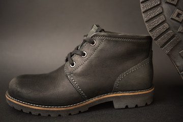vintage black boots on black background, retro shoes