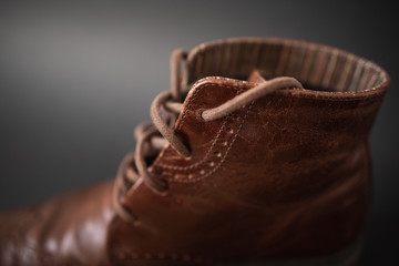 Vintage brown boots on black background, retro shoes