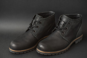 vintage black boots on black background, retro shoes