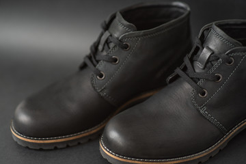 vintage black boots on black background, retro shoes