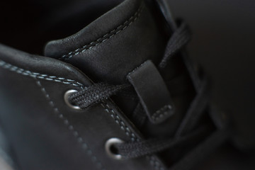 vintage black boots on black background, detail of retro shoes