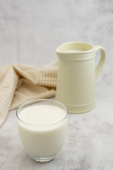 Jug and glass with milk on bright background isolated. Breakfast drink. Dairy.