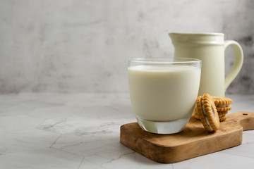 Jug and glass with milk on bright background isolated. Breakfast drink. Dairy.