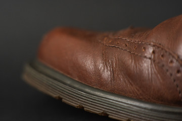 Vintage brown boots on black background, detail of retro shoes