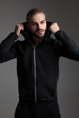 Obraz premium casual man fixing hood and looking away serious