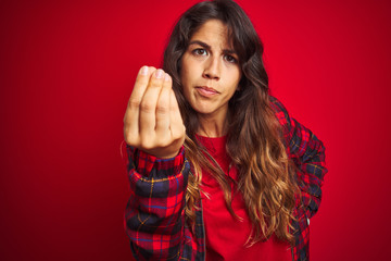 Young beautiful woman wearing casual jacket standing over red isolated background bored yawning...