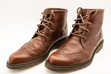 Vintage brown boots on white background, retro shoes