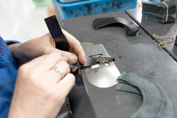 Fototapeta premium Lowering the edges of parts. Shoe production.