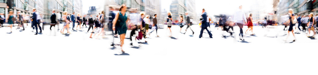 Walking people blur. Lots of people walking in the City of London. Wide panoramic view of people crossing the road. 