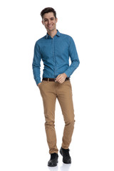 Fototapeta premium happy young smart casual man walking andwa smiling