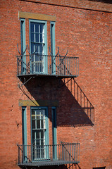 Obraz premium Fire escape steps on an old brick building