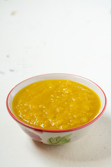 Vegetarian food in autumn season,pumpkin mash for making soup in bowl,copy space
