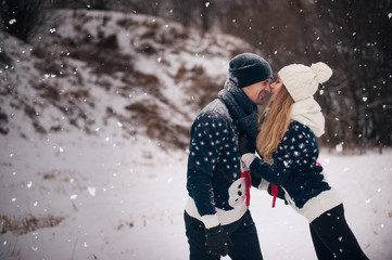 Young lovers couple hug each other dr winter walk in the park