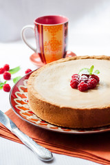 Coffee and cream cake with raspberries on a plate