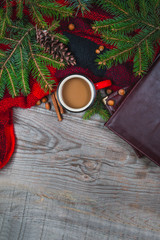 Hot coffee cup with cozy blanket on a wooden table with decorations