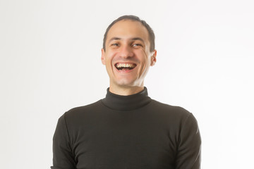 Portrait of a handsome young man smiling against white background