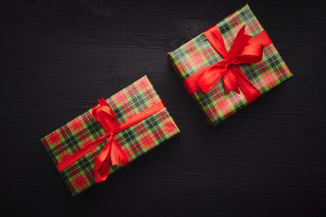 Christmas eve. Gifts on black wooden background.