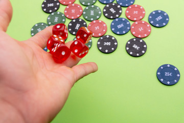 man throwing dice. Poker chips. Green background