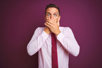 Young business man wearing elegant shirt and tie over purple isolated background shocked covering mouth with hands for mistake. Secret concept.