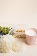 Breakfast Packed for school. Instant porridge, banana, bread and a mug of milk on a beige background. A proper Breakfast of the student. Copyspace