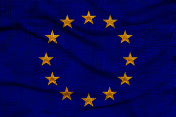 close-up photo of beautiful colored stylized European Union flag, symbol of united Europe on textured fabric, concept of tourism, emigration, economy and politics, close-up