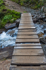 wooden bridge over alpine creek