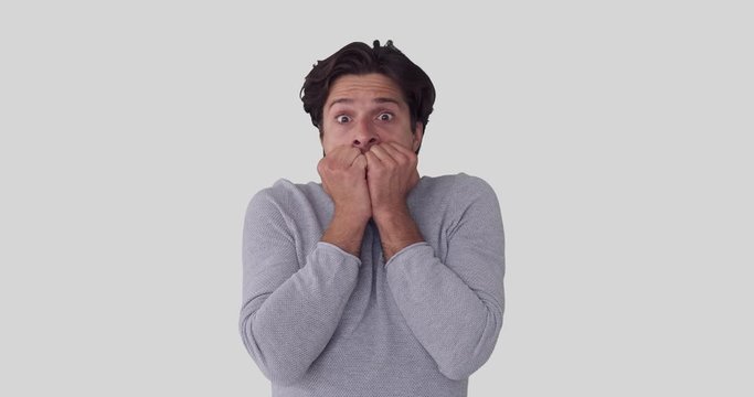 Shocked man feeling nervous and scared over white background