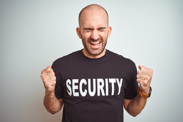 Young safeguard man wearing security uniform over isolated background excited for success with arms...