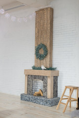 white room with fireplace. fireplace in the bedroom with Christmas decoration. wreath over the fireplace