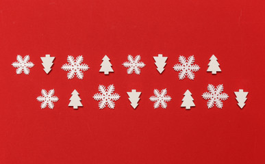 Seamless white Christmas ornaments on festive red background with copy space, top view. Christmas, winter holiday, new year concept.