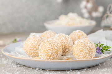 Homemade sweet white chocolate and coconut in a plate. Raffaello candy - snowball truffles on a Christmas table.