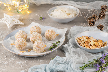 Homemade sweet white chocolate and coconut in a plate. Raffaello candy - snowball truffles on a Christmas table.