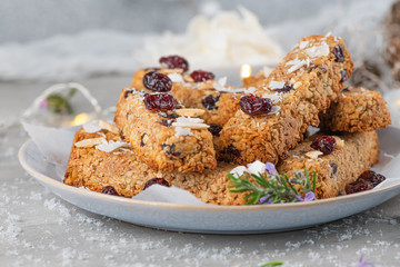 Granola bar. Healthy snack. Cereal granola bar with nuts, fruit, coconut and cranberries on a christmas table