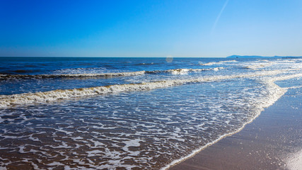 small waves on the sea coast in sunny weather
