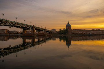 View of Chapelle Saint-Joseph and bridge Pont Saint-Pierre from the square Place Saint-Pierre at Sunset in Toulouse France - obrazy, fototapety, plakaty