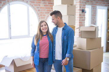 Young beautiful couple in love moving to new home, very happy and cheerful for new apartment