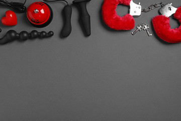 Different sex toys on dark background, flat lay. Space for text