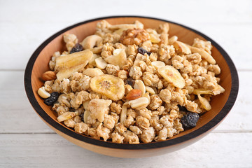 Tasty homemade granola on white wooden table. Healthy breakfast