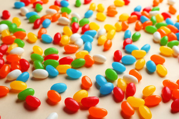 Colorful sweet jelly beans on beige background
