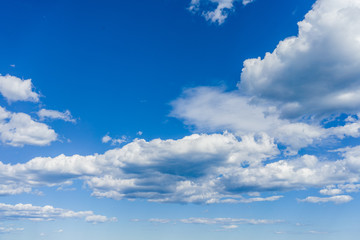 Naklejka na ściany i meble Blue sky on a sunny day with fluffy clouds