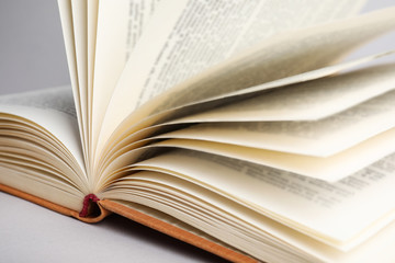 Closeup view of open book on light background