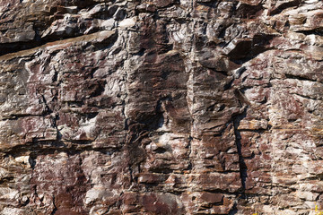 Wet mountain side rocky background after recent rain.
