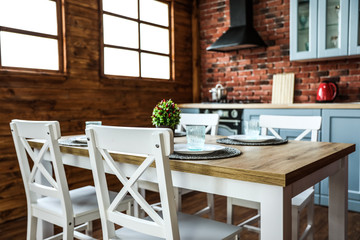 Stylish kitchen interior with dining table and chairs