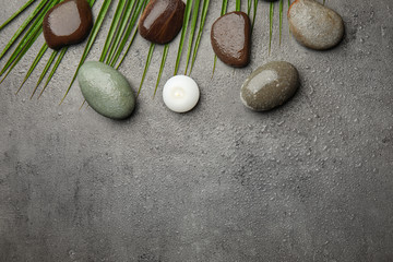 Flat lay composition with stones on grey background, space for text. Zen concept