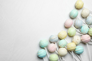 Sweet cake pops on light grey background, flat lay. Space for text