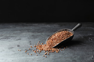 Fototapeta premium Buckwheat grains on grey table. Space for text