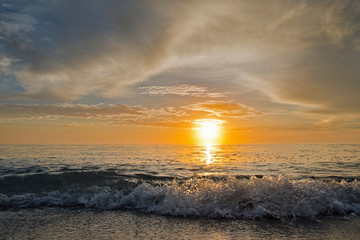 Sun on the Horizon at Sunset with Wave