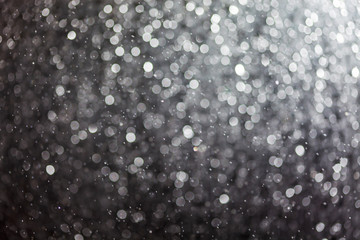 Abstract bokeh christmas lights texture on black background