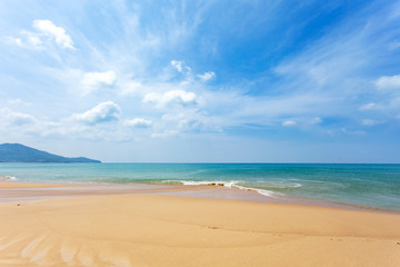 Tropical sandy beach with blue ocean and blue sky background image for nature background or summer background